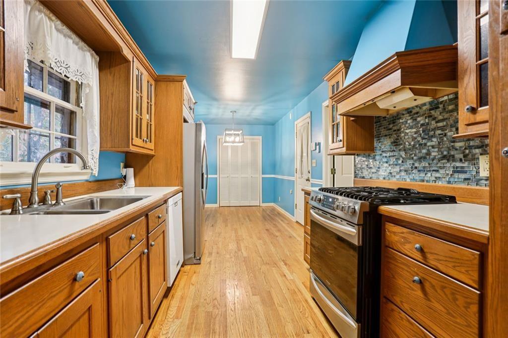 6300 East Stubbs Road Atlanta, GA 30349 - Photo 8 of 29 a kitchen with stainless steel appliances granite countertop a stove and a sink