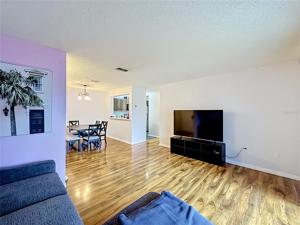 3705 Southwest 27th Street, Unit 922 Gainesville, FL 32608 - Photo 13 of 34 a living room with furniture and a flat screen tv