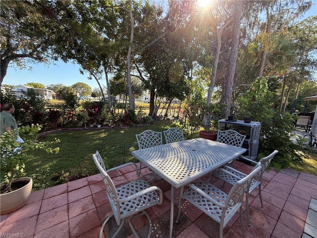 25 Bass Lane Naples, FL 34114 - Photo 13 of 17 a view of a wooden chairs and table in patio