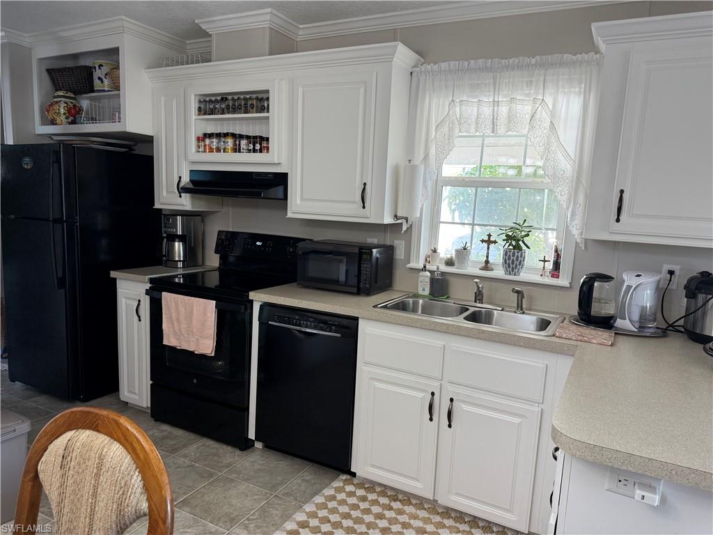 25 Bass Lane Naples, FL 34114 - Photo 5 of 17 a kitchen with granite countertop a refrigerator stove and sink