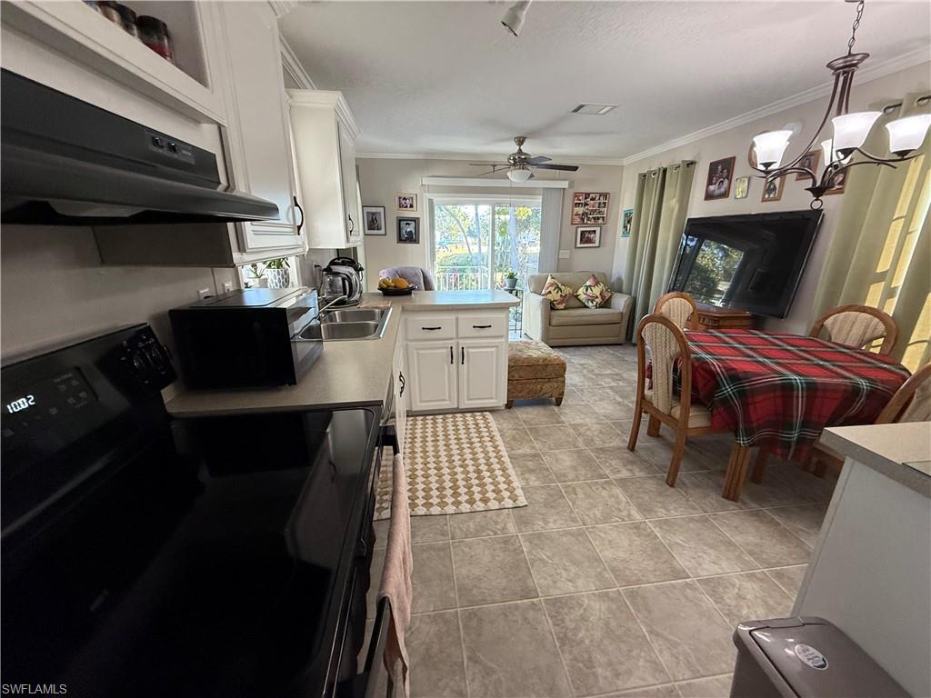 25 Bass Lane Naples, FL 34114 - Photo 17 of 17 a kitchen with a sink appliances and cabinets