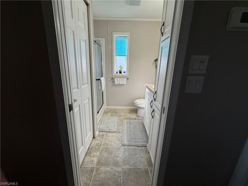 25 Bass Lane Naples, FL 34114 - Photo 6 of 17 a bathroom with a sink and a toilet