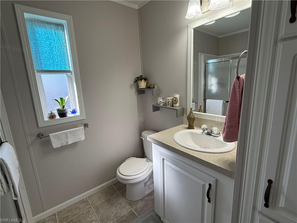25 Bass Lane Naples, FL 34114 - Photo 7 of 17 a bathroom with a toilet sink and mirror