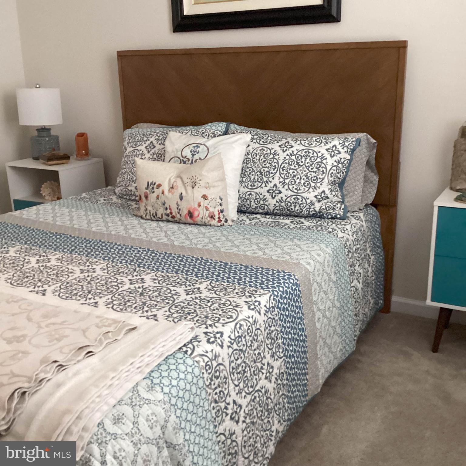 212 Bowline Drive Cambridge, MD 21613 - Photo 13 of 19 a bed sitting in a bedroom next to a lamp