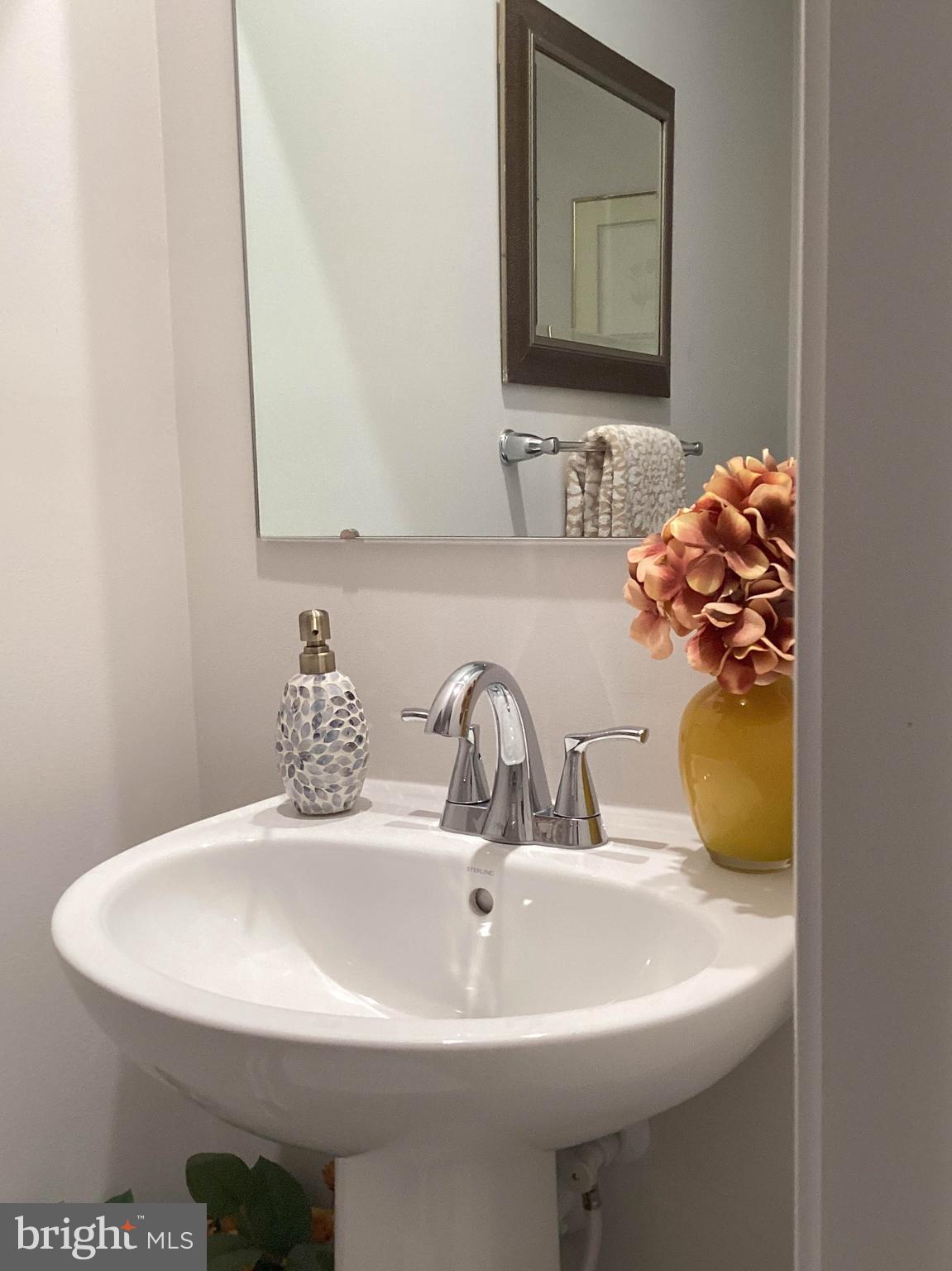 212 Bowline Drive Cambridge, MD 21613 - Photo 16 of 19 a bathroom with a sink and a mirror