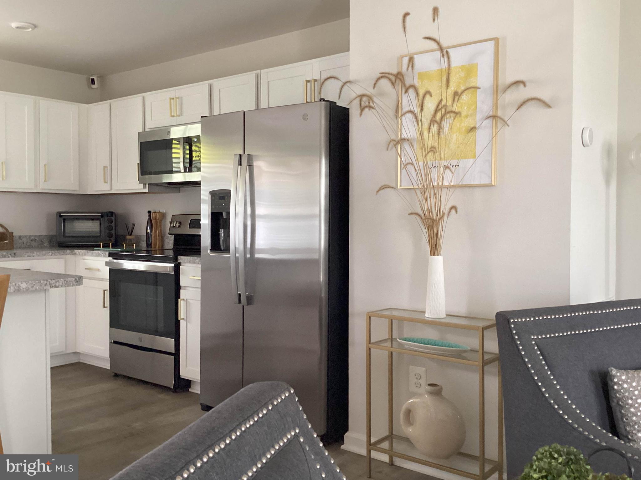 212 Bowline Drive Cambridge, MD 21613 - Photo 4 of 19 a kitchen with stainless steel appliances a refrigerator sink and stove