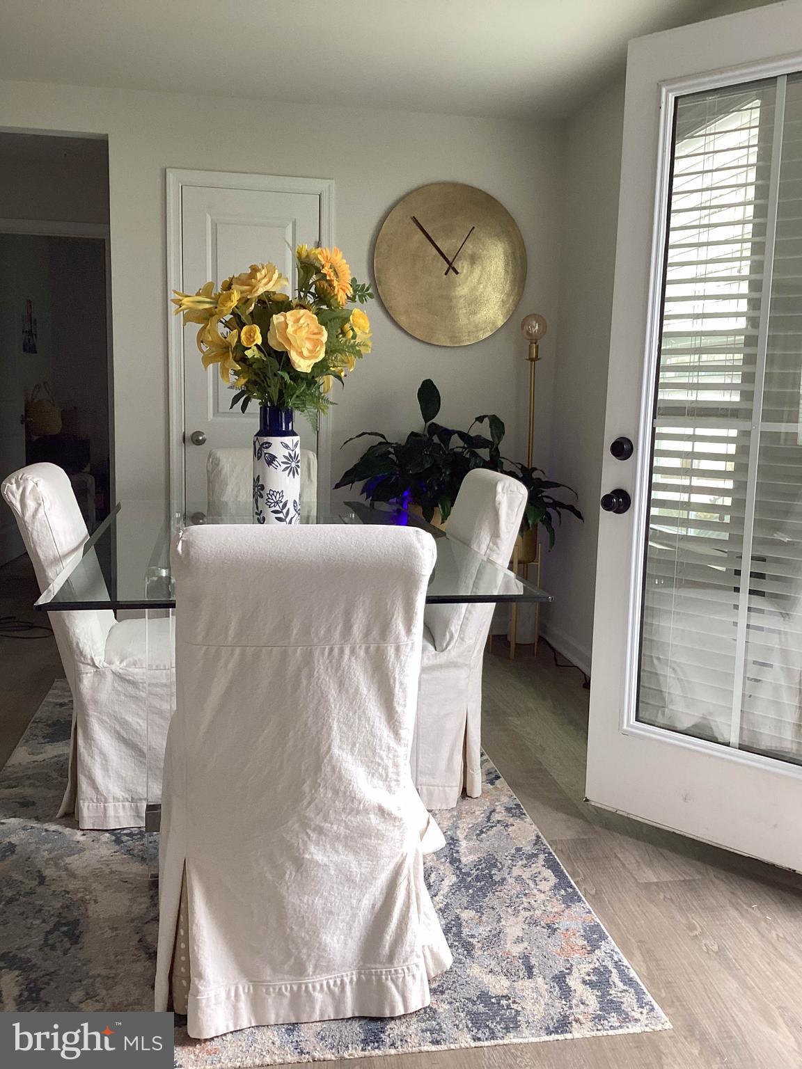 212 Bowline Drive Cambridge, MD 21613 - Photo 7 of 19 a living room with couches chairs and a mirror with wooden floor