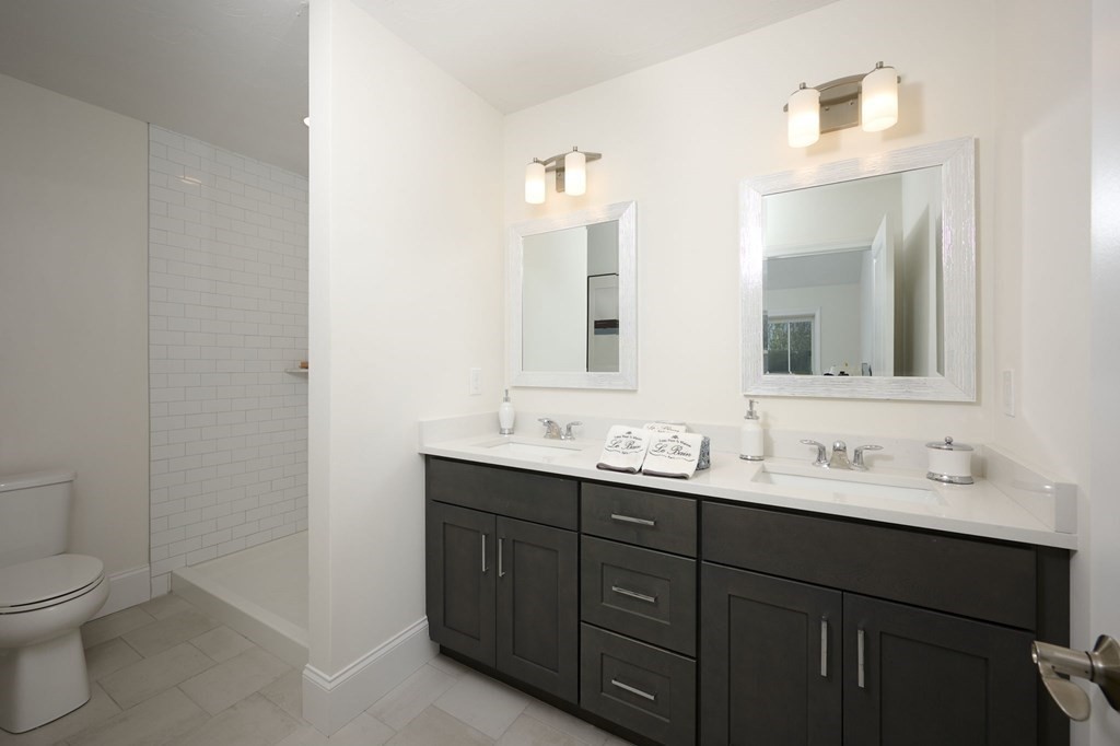 35 Metacomet Road, Unit 35 West Bridgewater, MA 02379 - Photo 15 of 34 a bathroom with a double vanity sink toilet and mirror