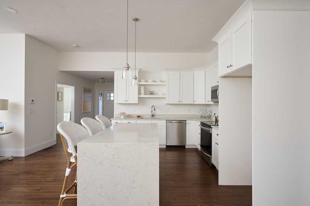 35 Metacomet Road, Unit 35 West Bridgewater, MA 02379 - Photo 6 of 34 a kitchen with white cabinets and stainless steel appliances