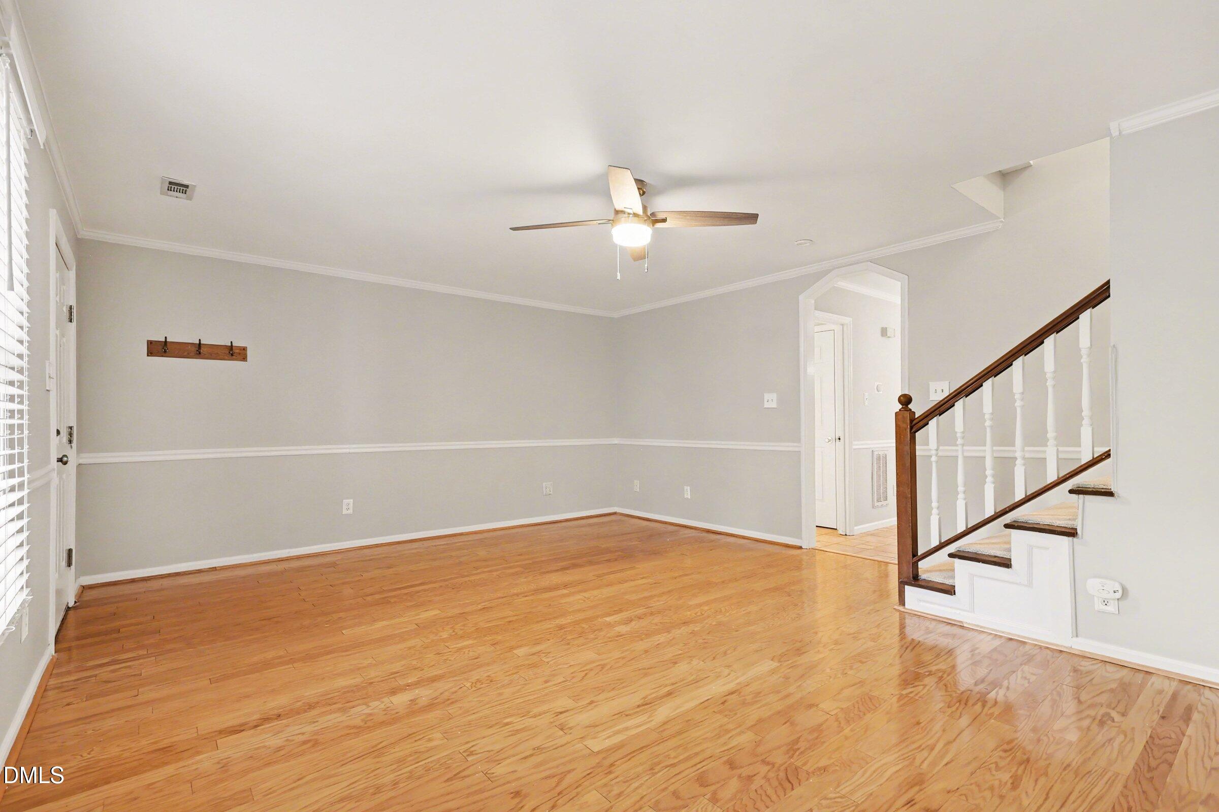 5645 Hamstead Crossing Raleigh, NC 27612 - Photo 9 of 35 a view of an empty room with wooden floor