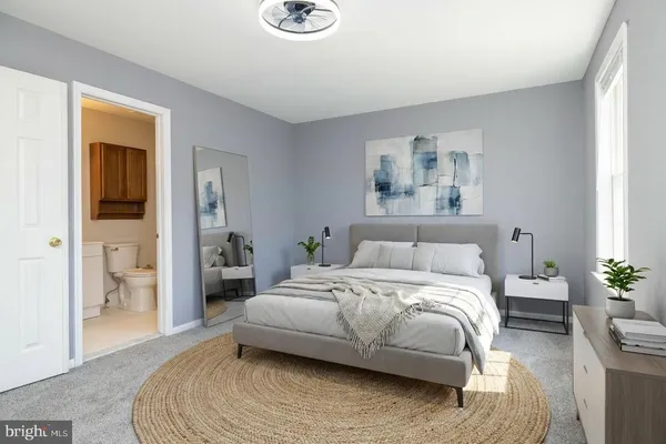 a bedroom with a bed and a painting on the wall