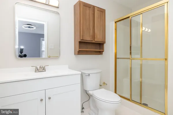 a bathroom with a toilet a sink and a mirror