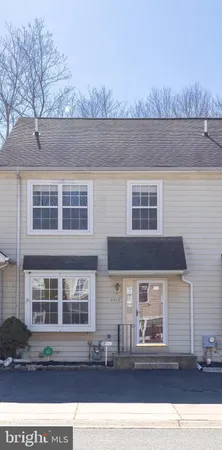 a front view of a house with a parking area