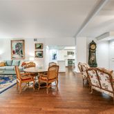 a living room with furniture wooden floor and a table