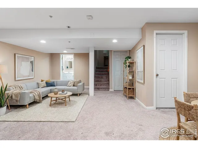 a living room with furniture and white doors