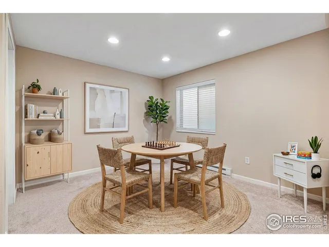 a dining room with furniture and window