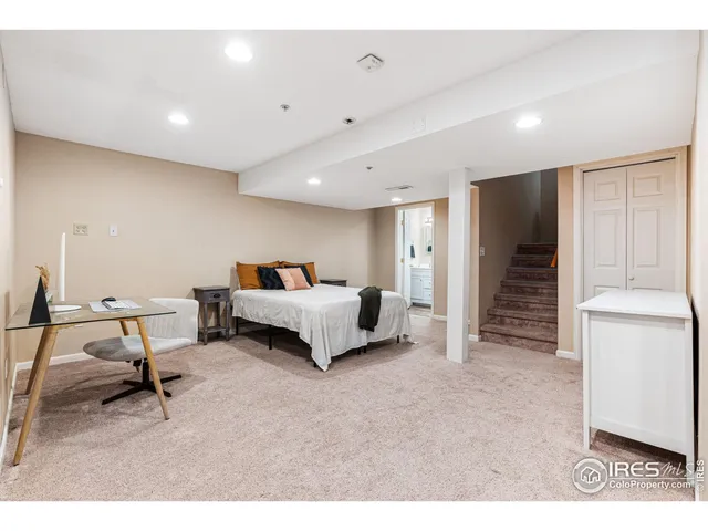 a spacious bedroom with a bed and a cabinets