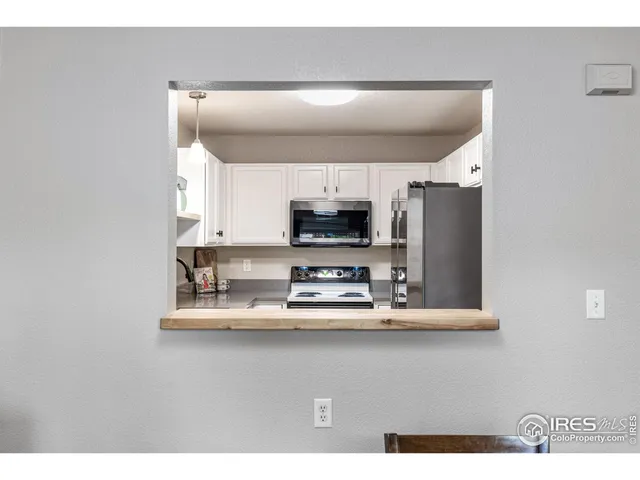 a kitchen with stainless steel appliances a sink and a microwave
