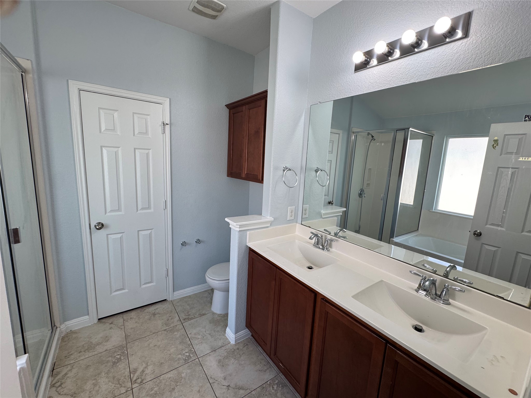 1520 Portchester Castle Path Pflugerville, TX 78660 - Photo 12 of 26 A sleek dual vanity and ample mirror space define this functional and well-appointed primary bath.
