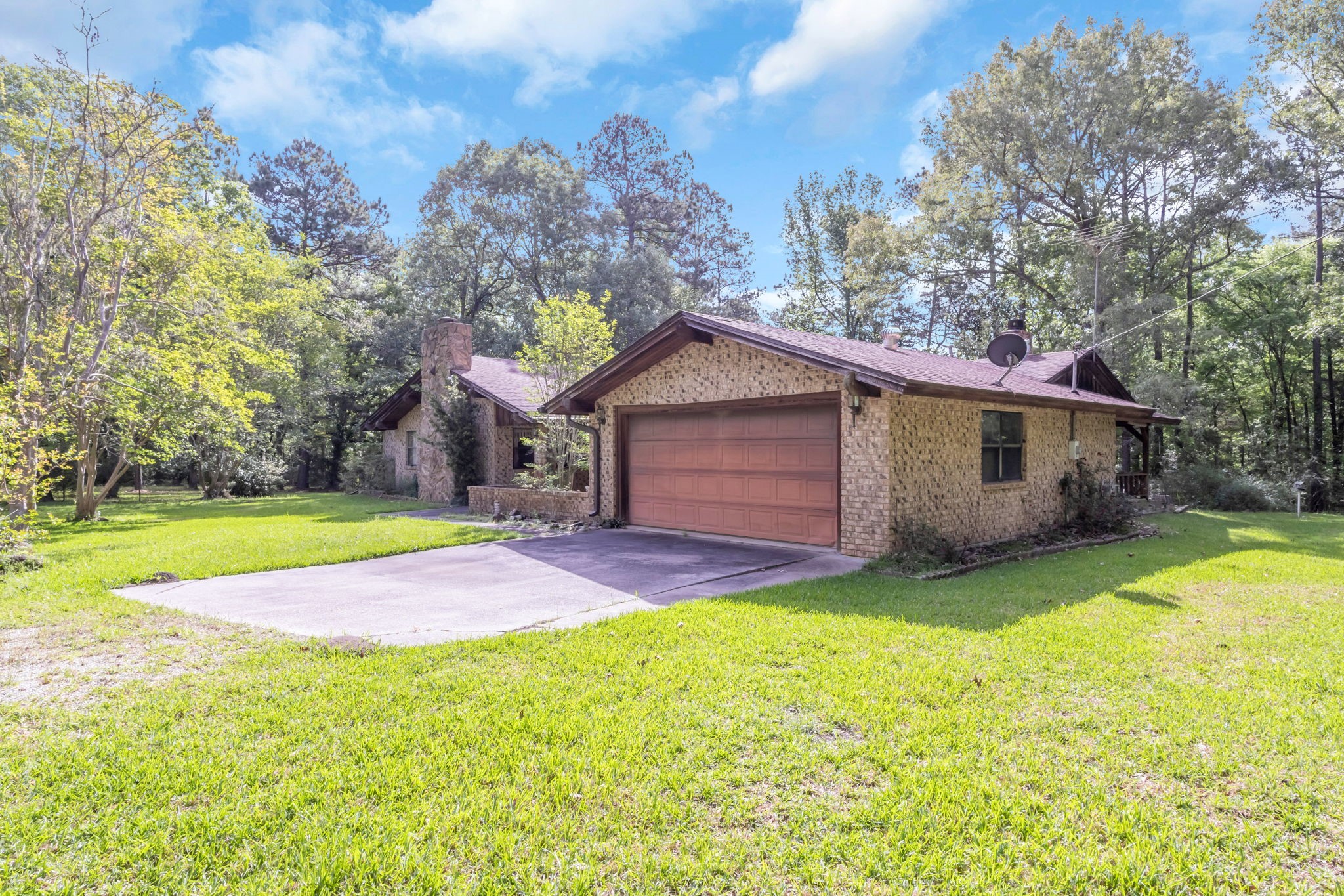 222 County Road 3085 Colmesneil, TX 75938 - Photo 25 of 50 a front view of a house with a yard and garage