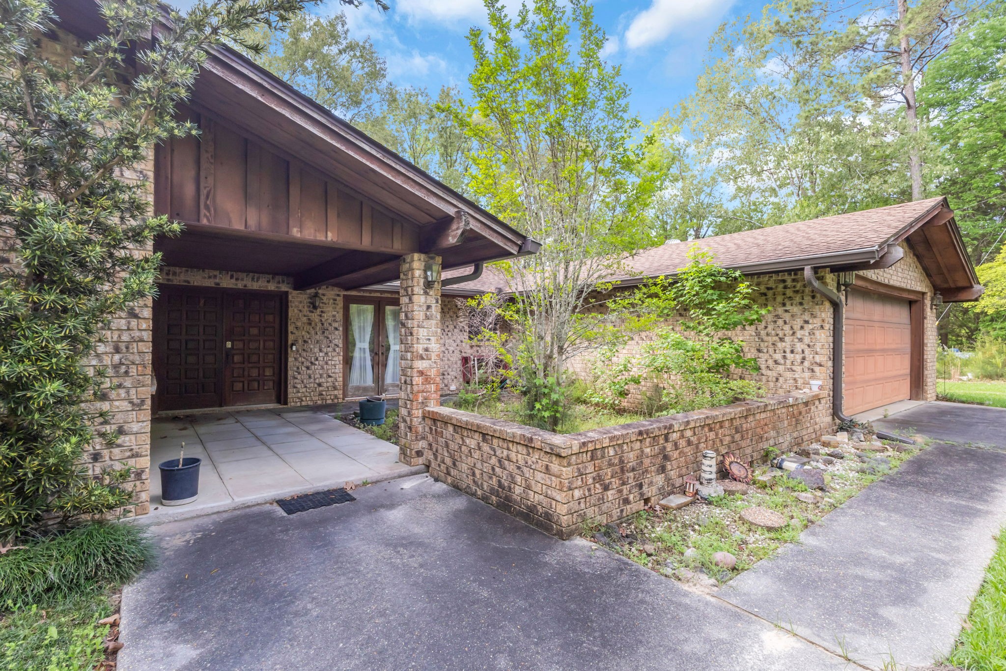 222 County Road 3085 Colmesneil, TX 75938 - Photo 26 of 50 a view of a house with a small yard plants and large tree