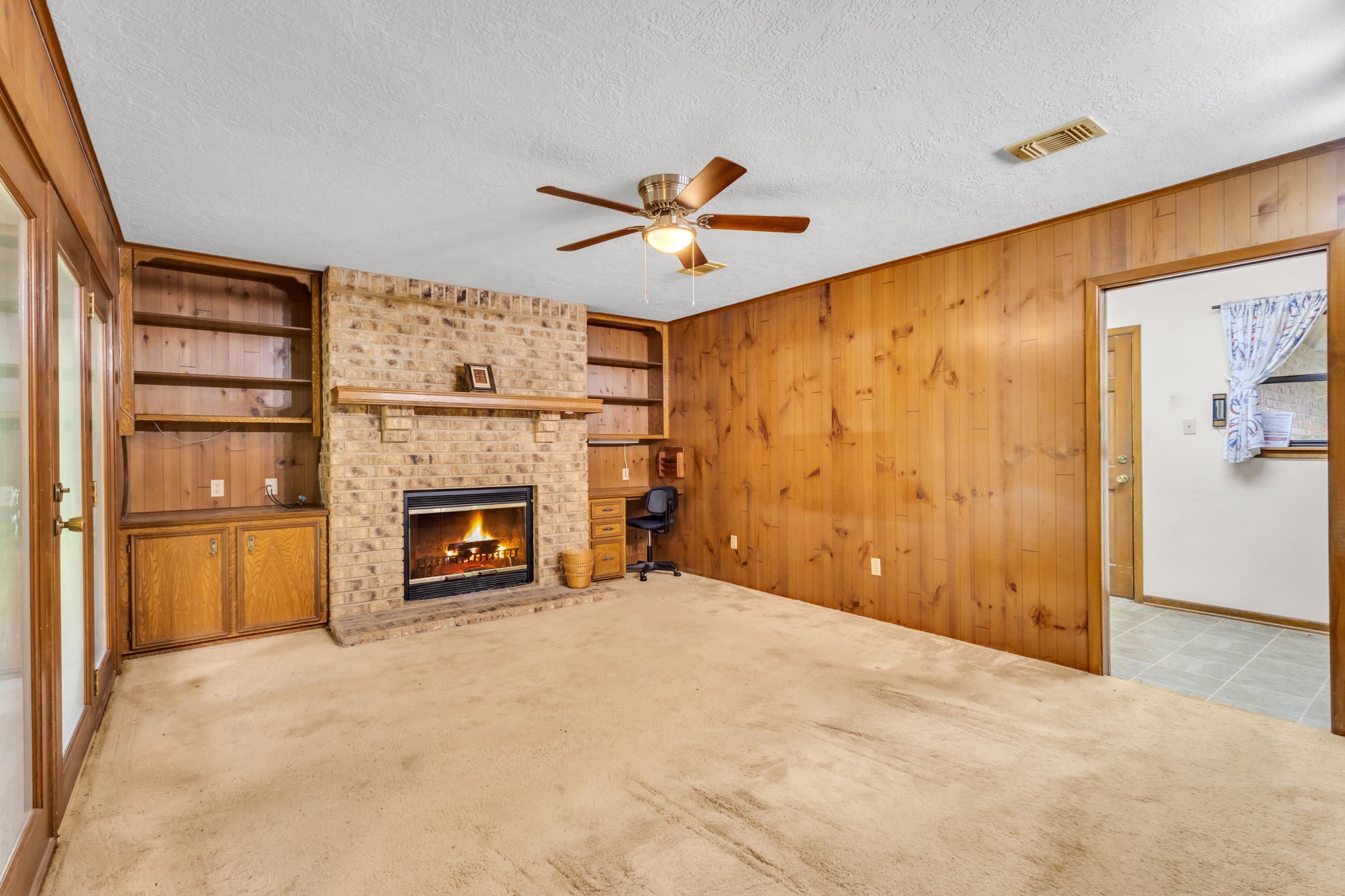 222 County Road 3085 Colmesneil, TX 75938 - Photo 29 of 50 a view of a livingroom with a fireplace a ceiling fan and window