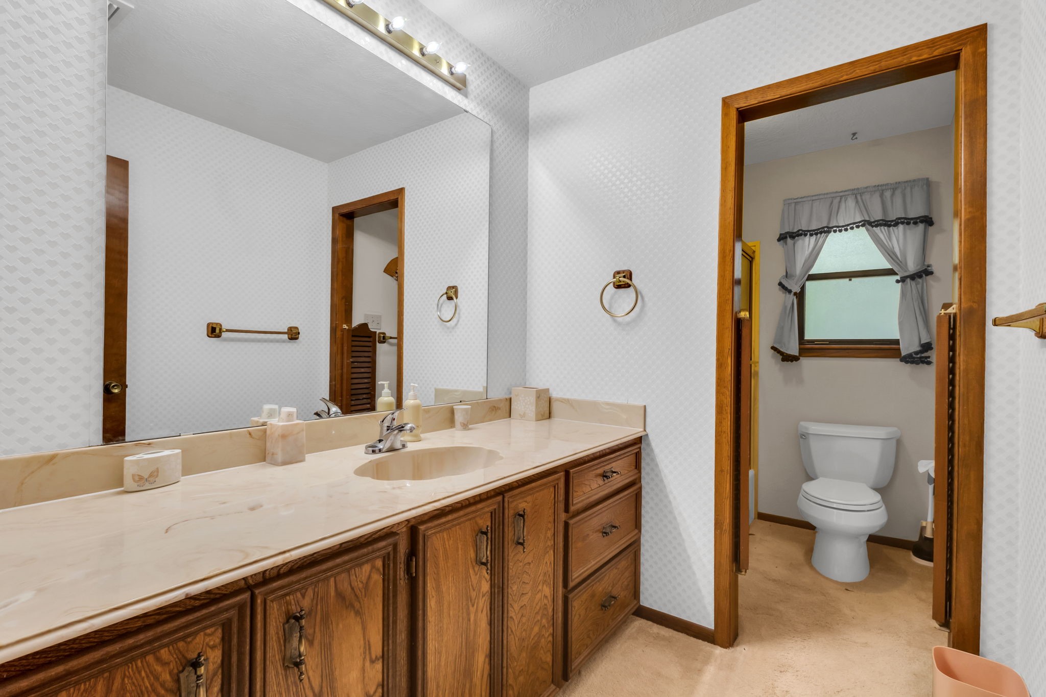 222 County Road 3085 Colmesneil, TX 75938 - Photo 34 of 50 a bathroom with a granite countertop sink a toilet and mirror