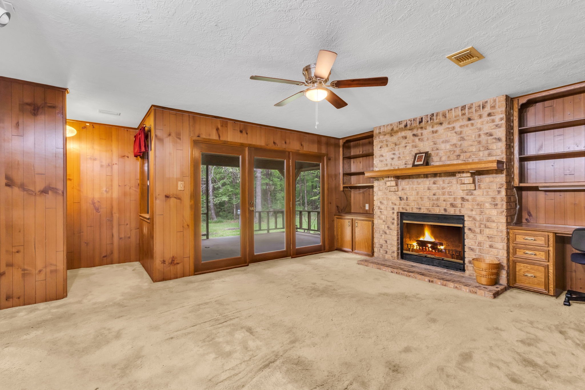 222 County Road 3085 Colmesneil, TX 75938 - Photo 10 of 50 a view of an empty room with a fireplace and a window