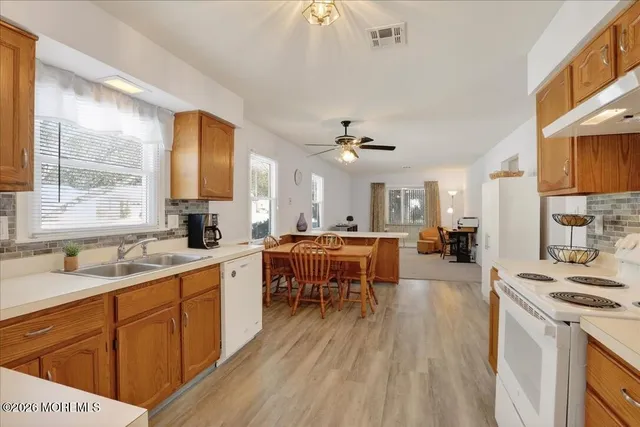 a large kitchen with a lot of counter space and a sink