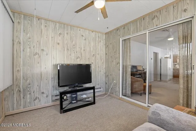 a living room with projector and a flat screen tv