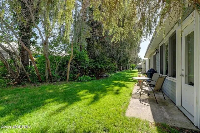 a view of a backyard with sitting area