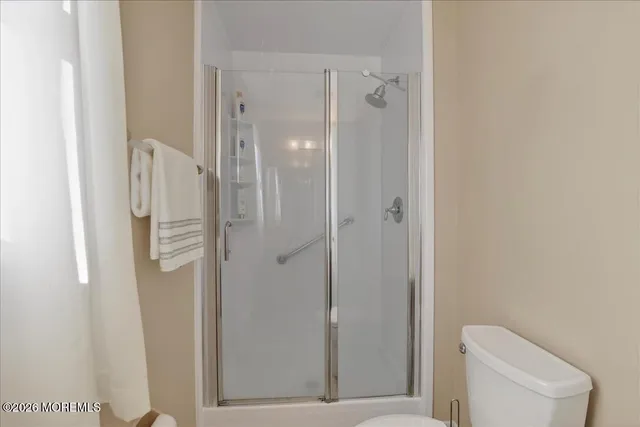 a bathroom with a shower and toilet