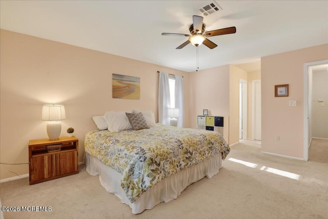 32 Abbey Road Brick, NJ 08723 - Photo 25 of 44 a spacious bedroom with a bed and a ceiling fan
