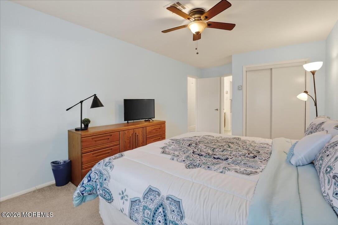 32 Abbey Road Brick, NJ 08723 - Photo 30 of 44 a bedroom with a bed and a chandelier