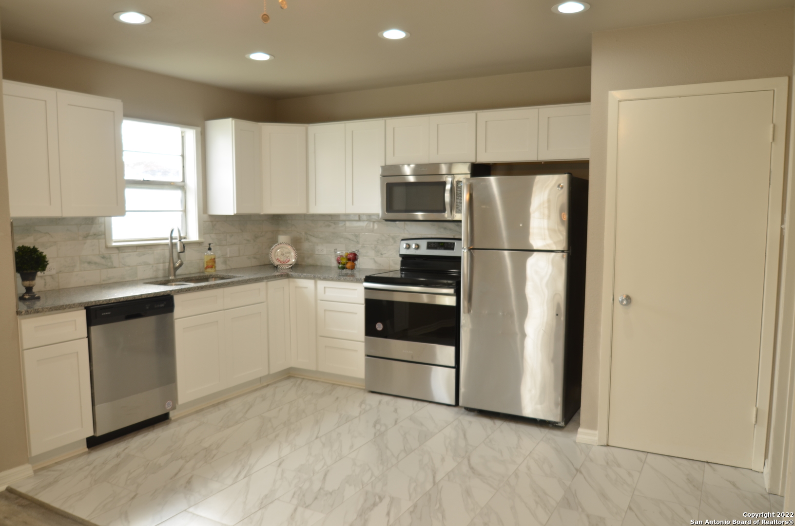 515 Mitchell Avenue Schertz, TX 78154 - Photo 1 of 1 a kitchen with white cabinets and white appliances