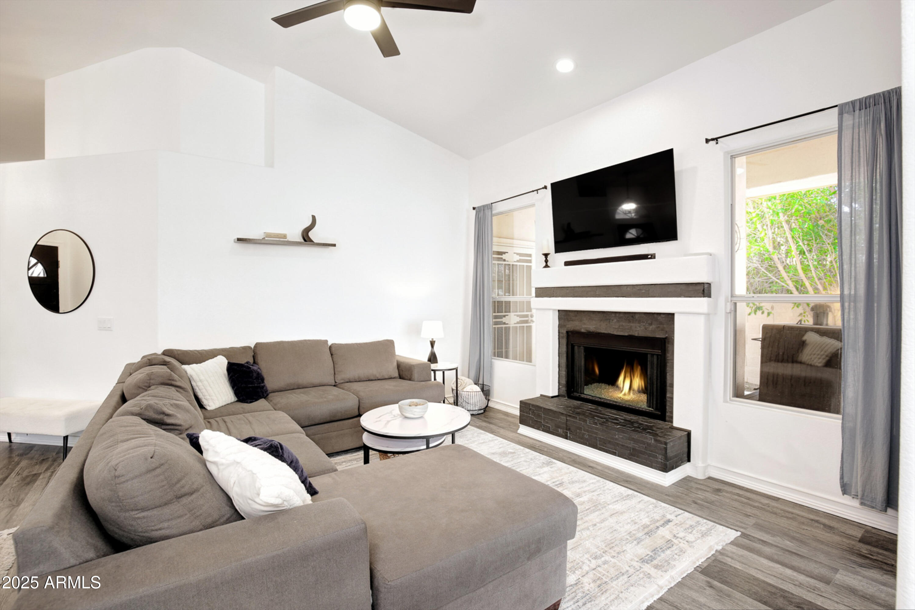 6458 East Raftriver Street Mesa, AZ 85215 - Photo 12 of 75 a living room with furniture and a fireplace