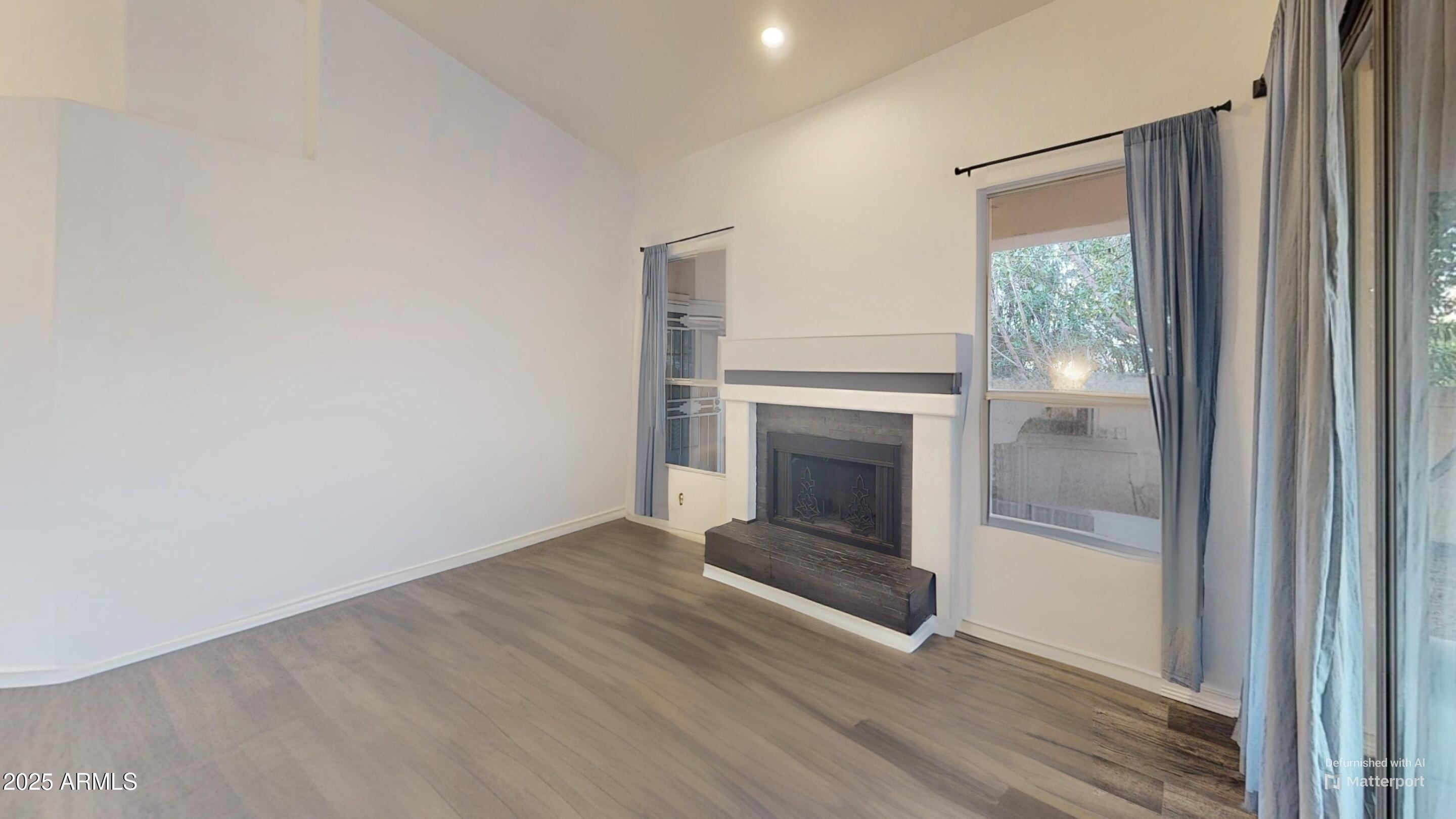 6458 East Raftriver Street Mesa, AZ 85215 - Photo 14 of 75 a view of a livingroom with wooden floor and a fireplace