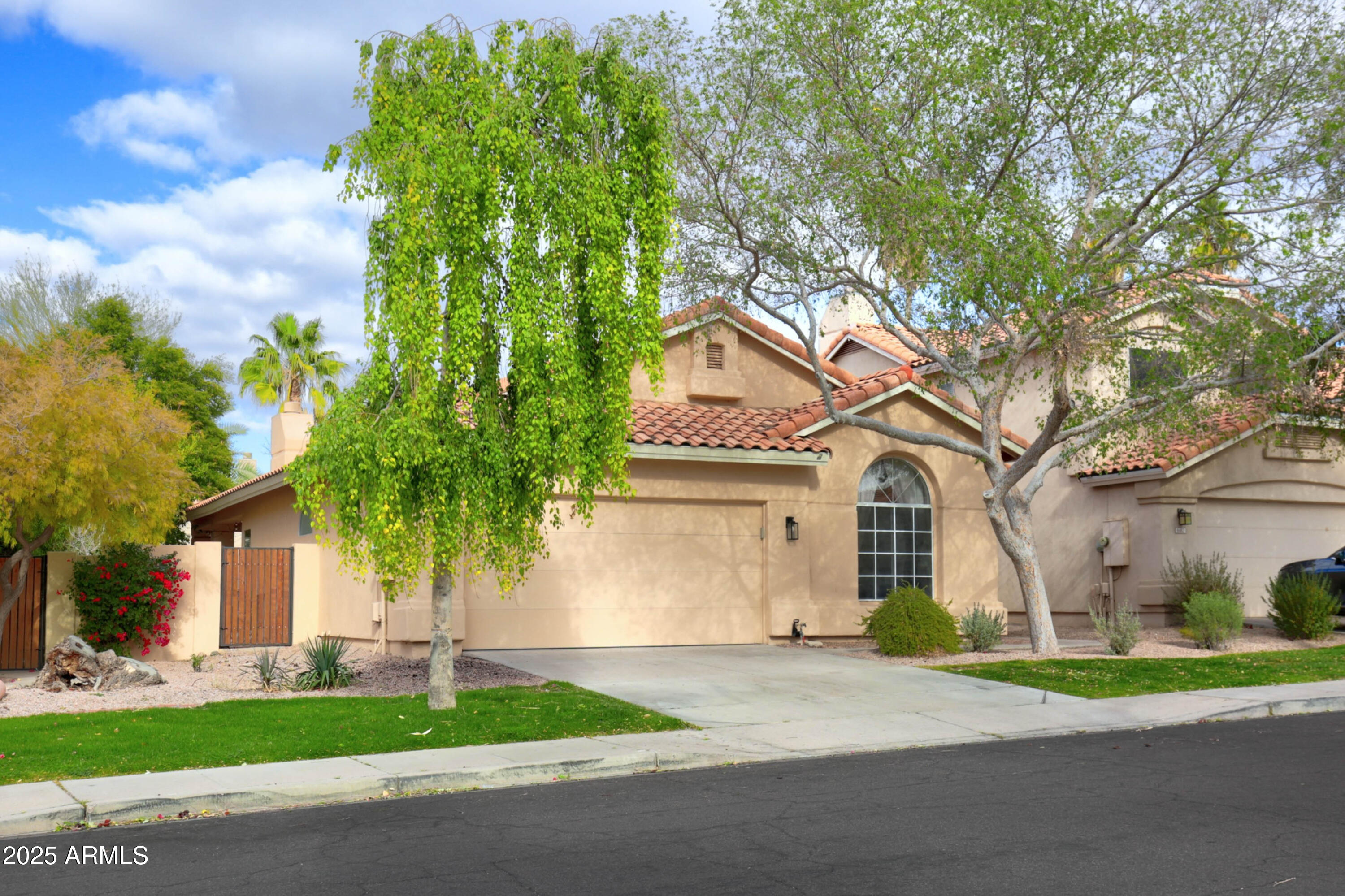 6458 East Raftriver Street Mesa, AZ 85215 - Photo 2 of 75 a front view of a house with a yard and garage