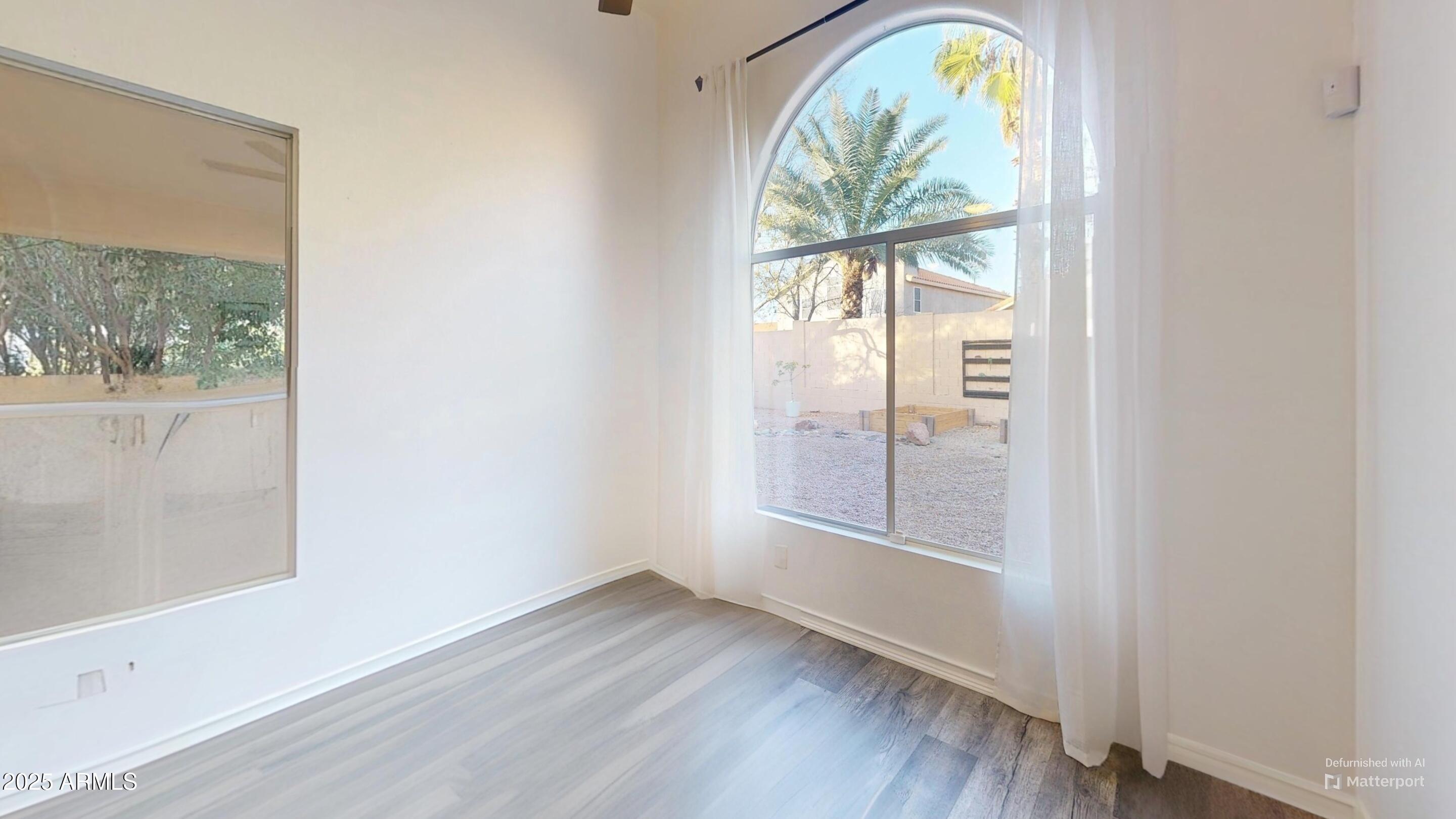 6458 East Raftriver Street Mesa, AZ 85215 - Photo 20 of 75 an empty room with wooden floor and a window
