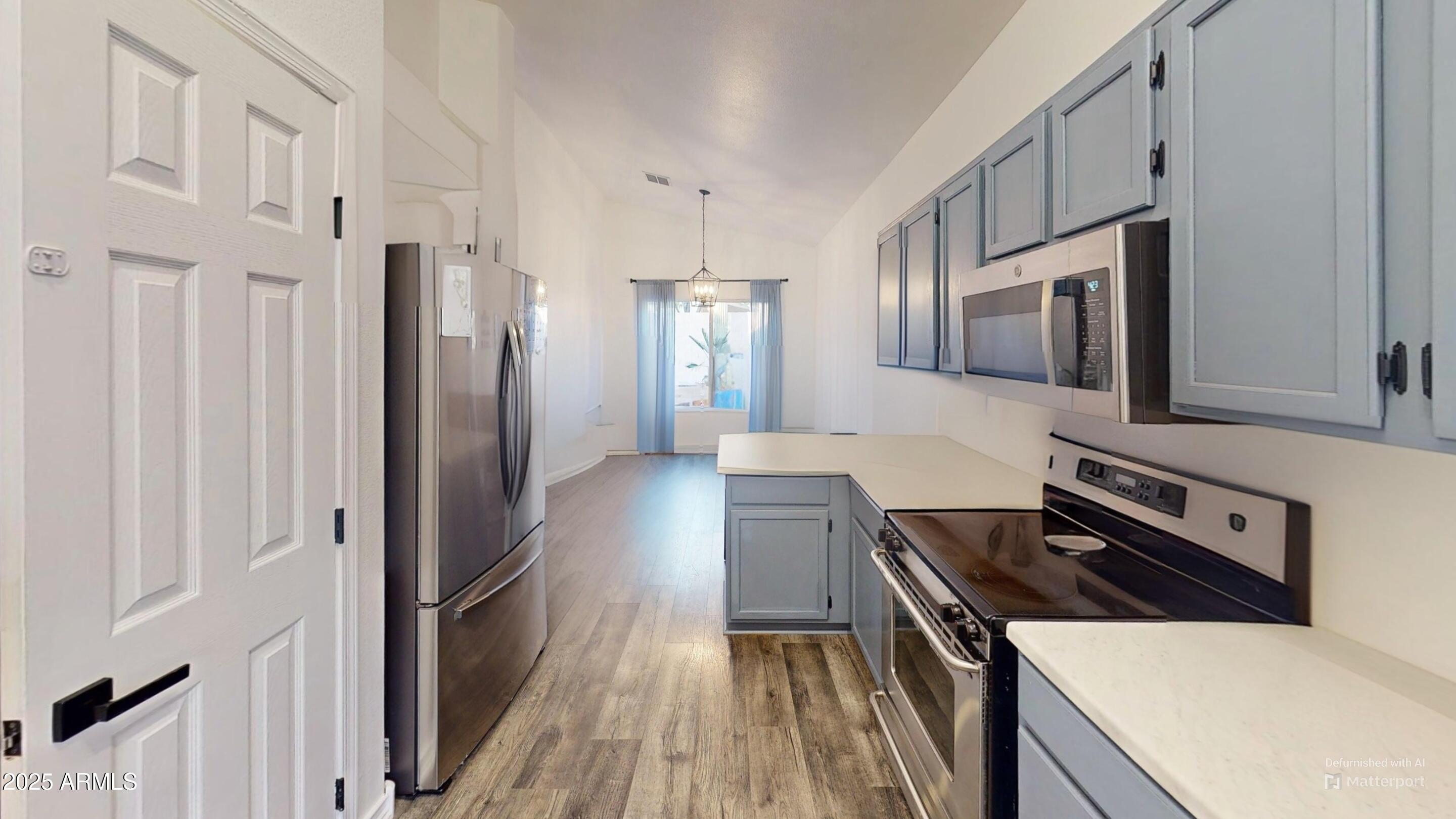 6458 East Raftriver Street Mesa, AZ 85215 - Photo 25 of 75 a kitchen with stainless steel appliances a refrigerator and a stove top oven