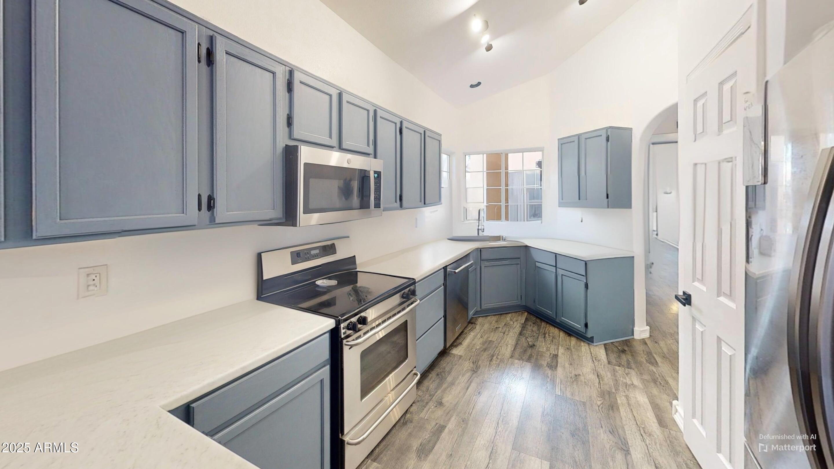 6458 East Raftriver Street Mesa, AZ 85215 - Photo 26 of 75 a kitchen with stainless steel appliances a refrigerator sink and cabinets