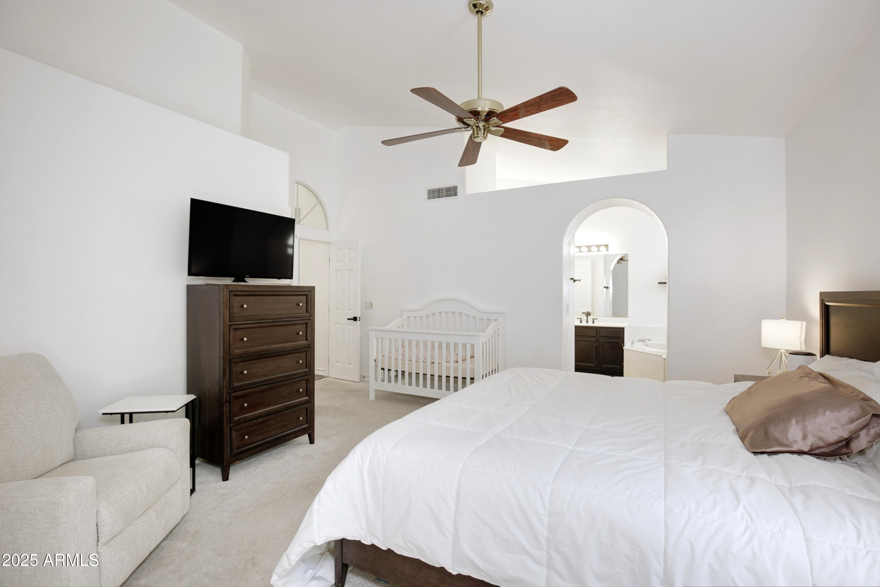 6458 East Raftriver Street Mesa, AZ 85215 - Photo 34 of 75 a bedroom with a bed and a flat screen tv