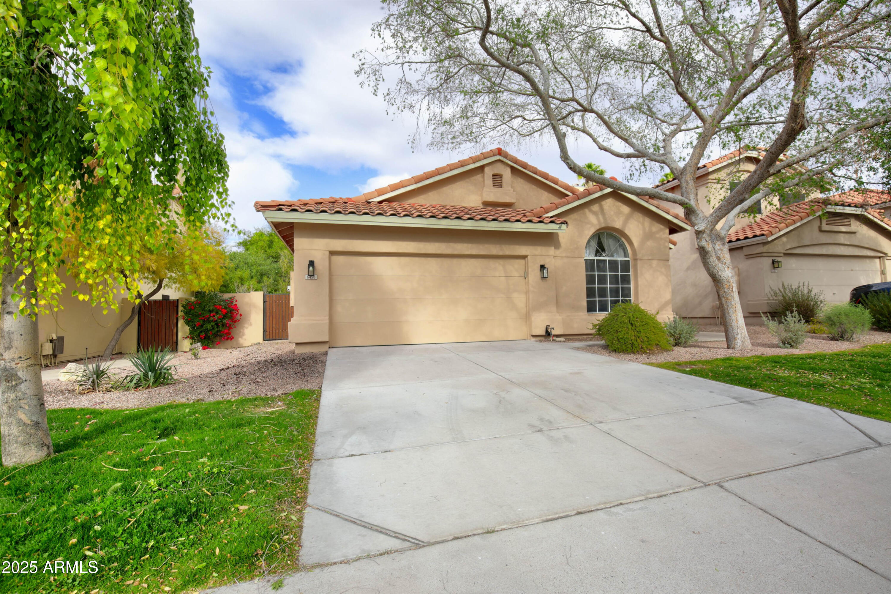 6458 East Raftriver Street Mesa, AZ 85215 - Photo 4 of 75 a front view of a house with garden