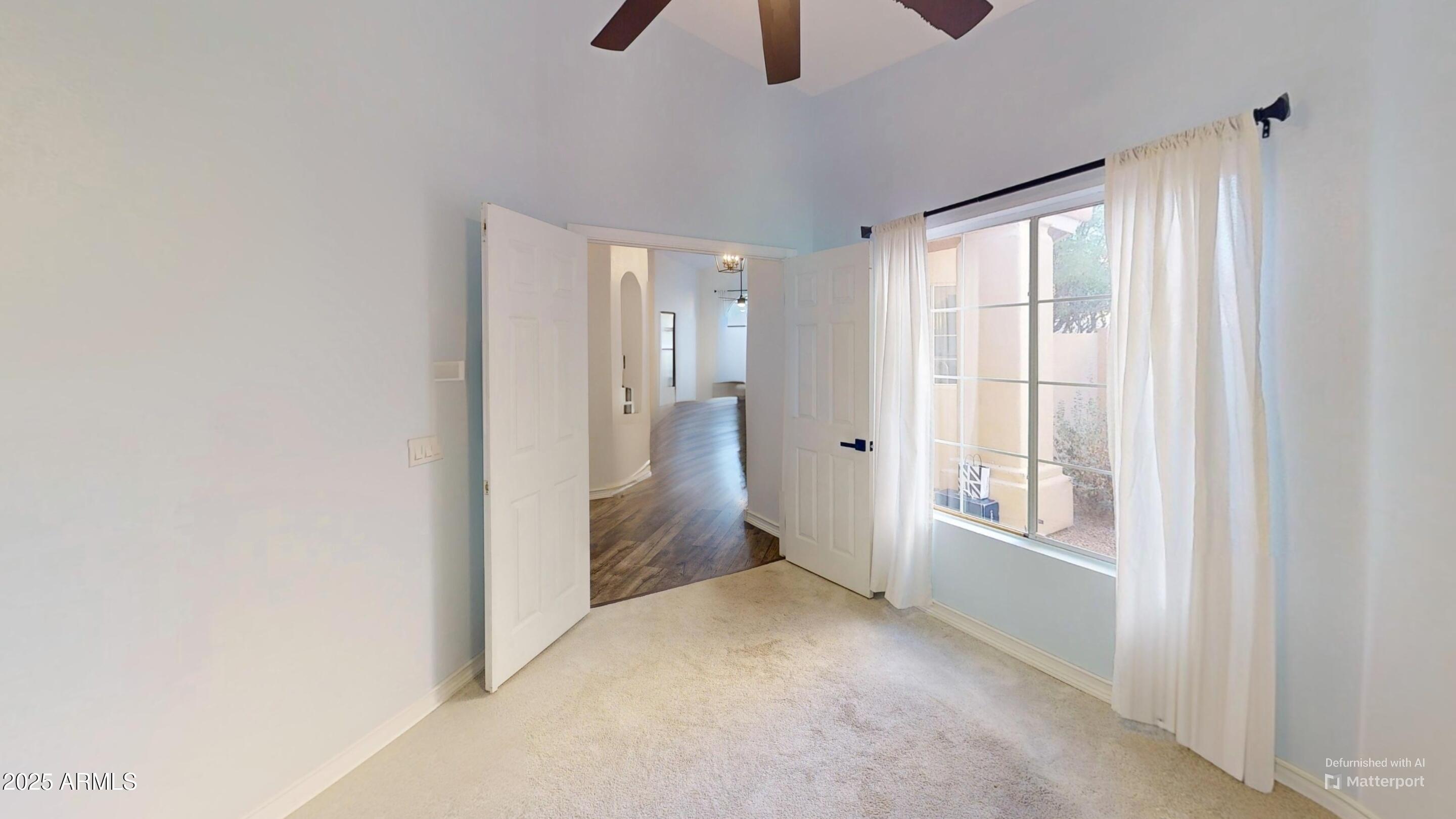 6458 East Raftriver Street Mesa, AZ 85215 - Photo 47 of 75 a view of an empty room with chandelier fan and fire place