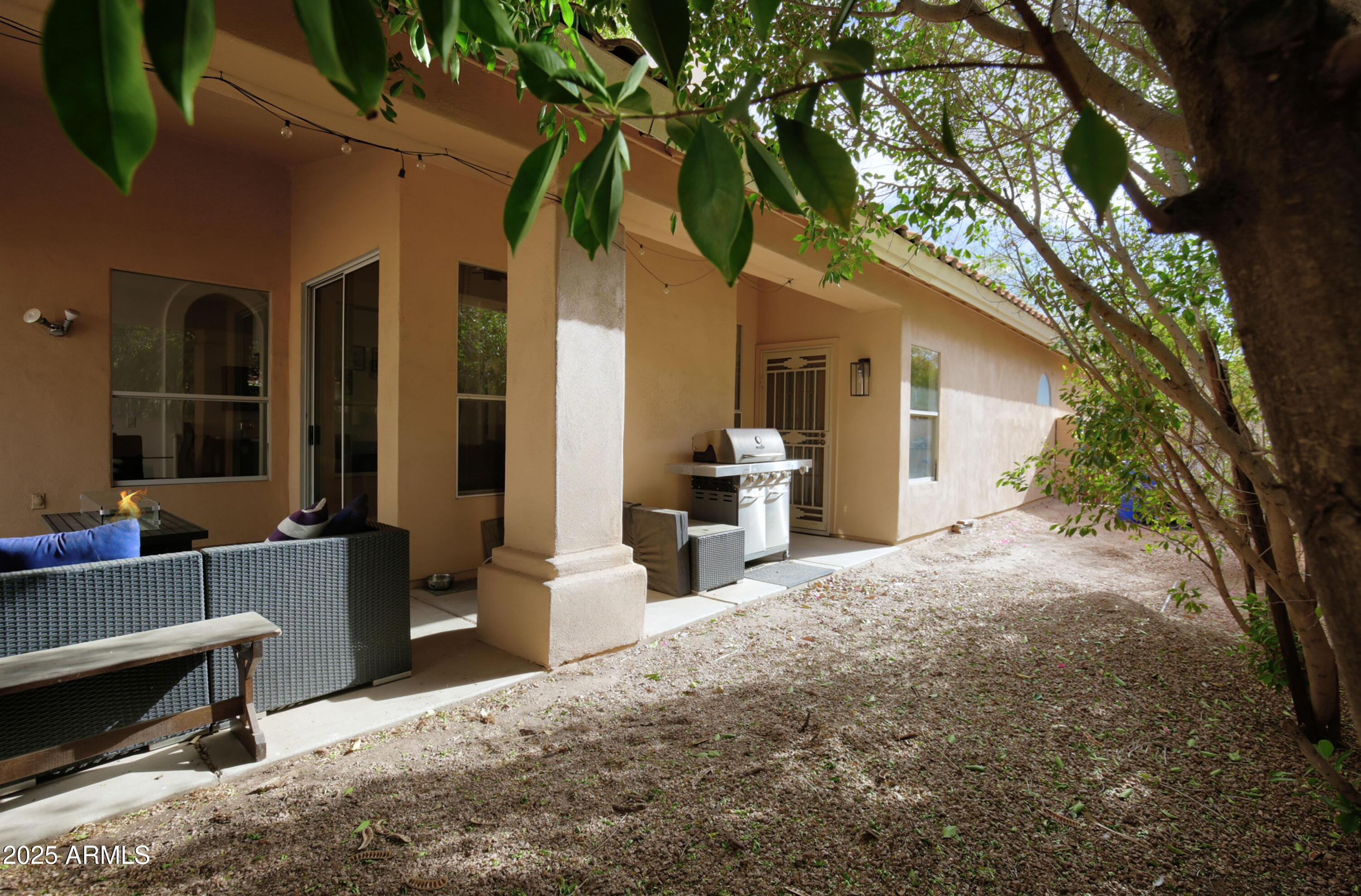 6458 East Raftriver Street Mesa, AZ 85215 - Photo 60 of 75 a view of a house with a couches and a tree