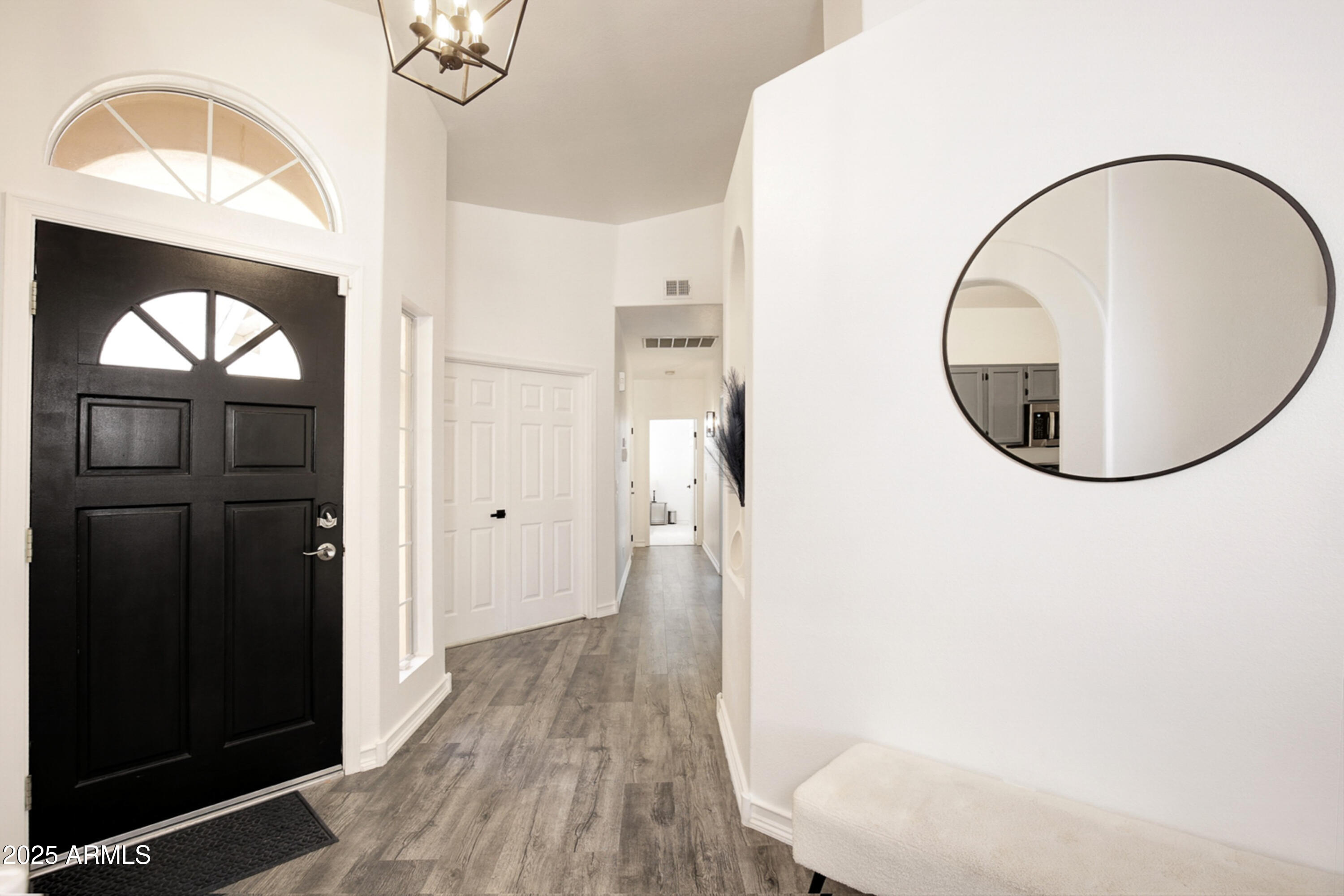 6458 East Raftriver Street Mesa, AZ 85215 - Photo 8 of 75 a picture of a room with wooden floor and mirror