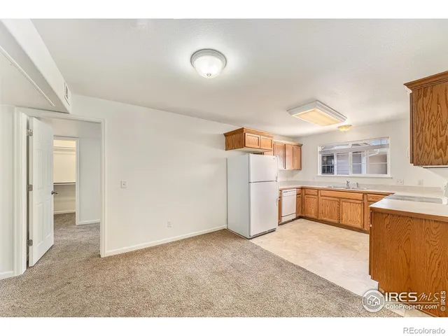 a kitchen with stainless steel appliances a refrigerator and a cabinets