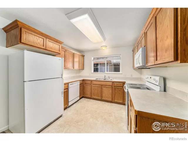 a kitchen with a refrigerator and a sink