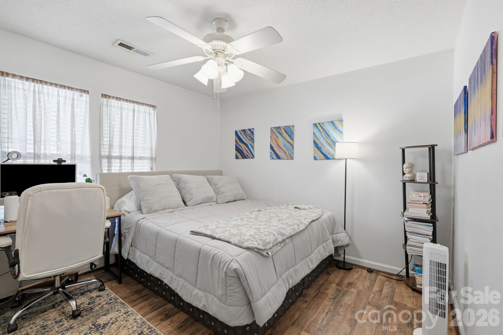 51 Sunview Circle Arden, NC 28704 - Photo 12 of 31 a bedroom with a large bed and a chandelier