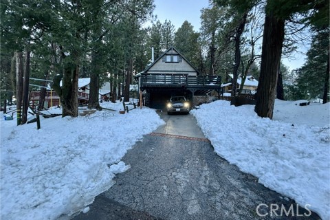 a view of a house with a yard covered with trees